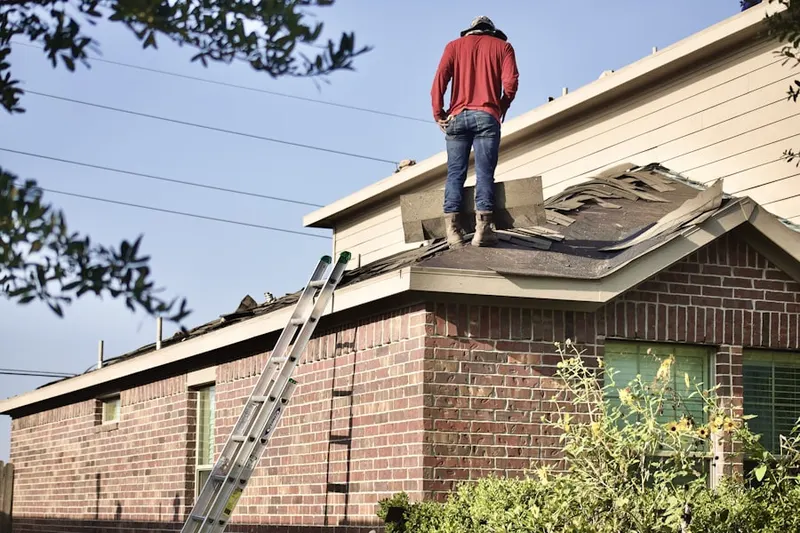 Professional roofer working on a residential roof in Waldorf